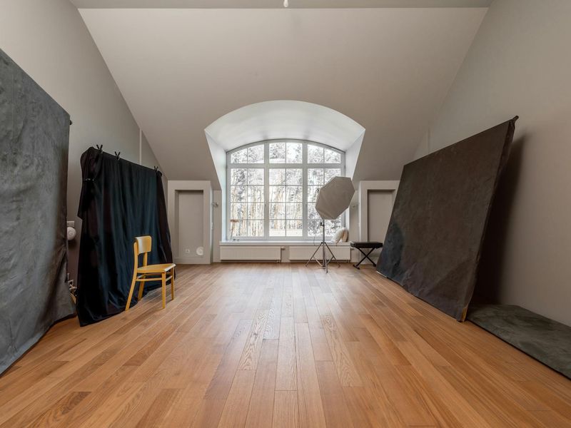 Minimalist yoga studio with wooden floors and large windows