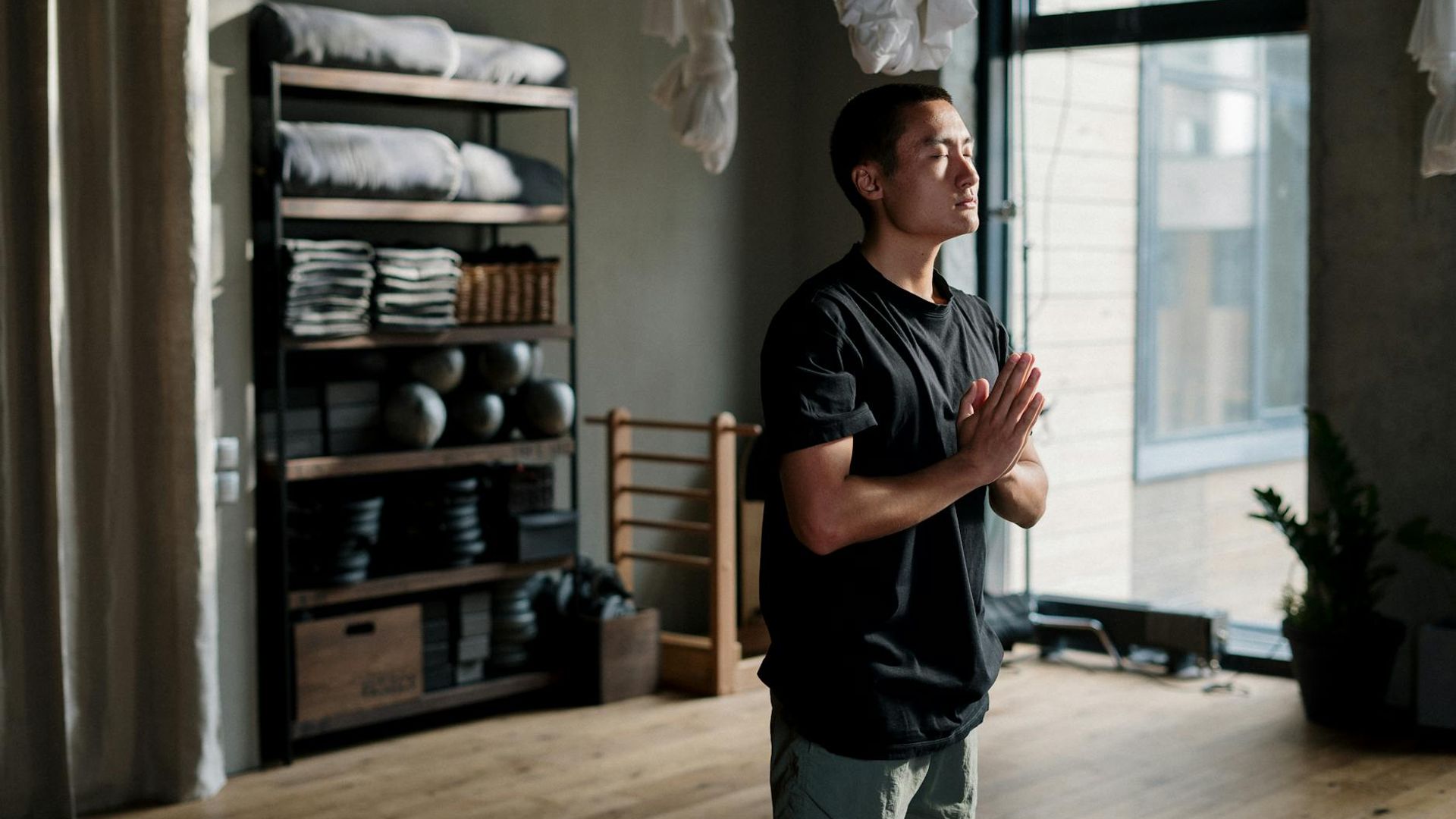 Serene indoor yoga studio with soft sunlight and plants