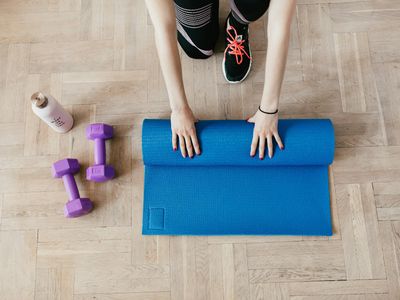 Yoga mat and a bottle of water on floor
